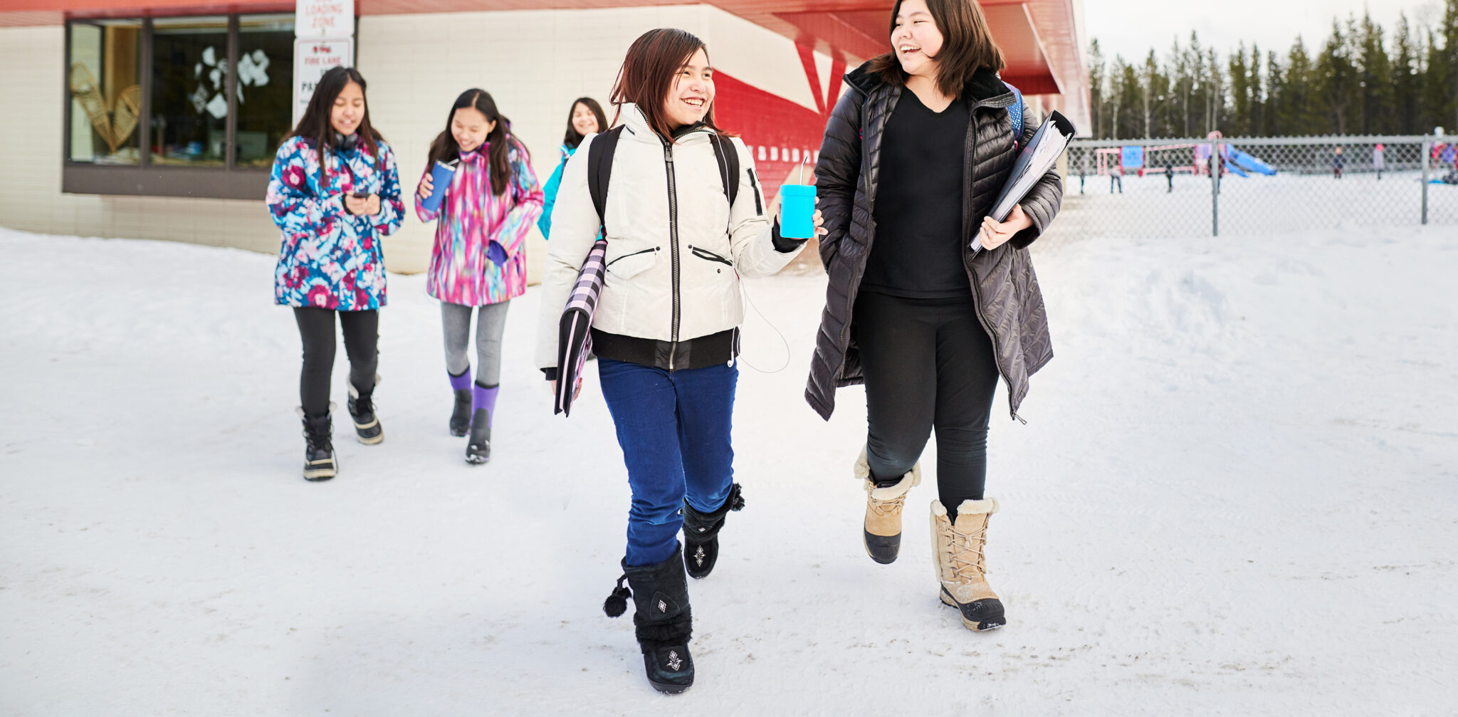 Group of indigenous girls walking outside of their school.